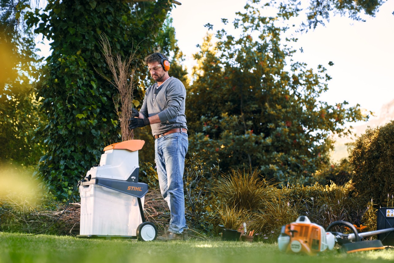 Egy férfi STIHL aprítógéppel a kertben